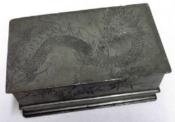 A Chinese Pewter Box of rectangular form, with pull-off lid, impressed with dragons and sprigs of