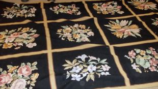 An Aubusson style Needlepoint Carpet, floral designs on a panelled noir ground, 8ft 10” x 5ft 9”