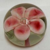 A 20th Century Glass Paperweight, the centre moulded with pink floral design, 3” diameter