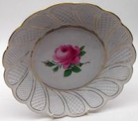 A modern Meissen circular Plate, the centre painted with a rose spray within a gilded and latticed