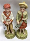 A pair of Robinson & Leadbetter Bisque Figures of young boy and young girl, decorated throughout
