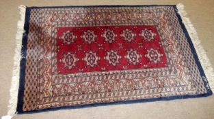 A small Caucasian Rug, multi gull border, central panel of lozenges on mainly red/rust field, 3ft