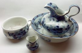 A Dunn Bennett & Co Pretoria Wash Bowl and Jug, decorated in blue and gilt on a cream background;