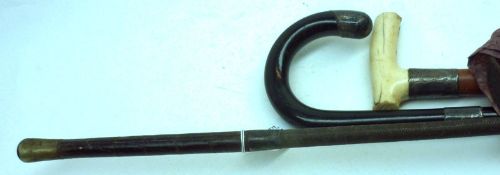 A Mixed Lot: Bone-handled Walking Cane with Silver banding; Ebonised Walking Cane with Silver