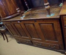 An 18th Century Oak Blanket/Mule Chest with lifting lid over a four panelled front and fitted