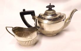 An Edwardian Bachelors Teapot, oval shaped with half-fluted decoration, ebonised handle and