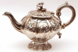 A Victorian Teapot, melon shaped with elaborate embossed panels of flowers and foliage, floral sprig