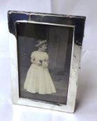 A George V small plain Silver Mounted Photograph Frame, rectangular shaped with wooden easel back,
