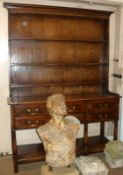 An early 20th Century Oak Dresser, plain plate rack back, the frieze below fitted with five