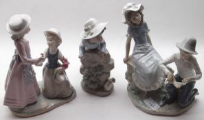 A group of three Nao Figurines: girl with puppy; girls with flowers; further figurine of boy and