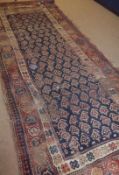 A Caucasian Carpet with triple gull border, central panel of geometric designs, mainly blue, red and