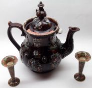 A large Measham Barge Ware Teapot, of typical form, decorated with coloured sprigs on a brown