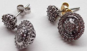 A pair of high grade precious metal all Diamond set Stud Earrings with two roundels of pavé set