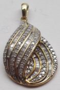 A hallmarked 9ct White Gold all pavé, baguette and brilliant cut Diamond Swirl Design Pendant,