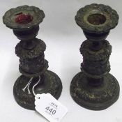A pair of 19th Century bronzed finish small squat Candlesticks, applied with floral decoration, to