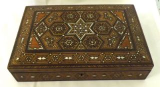 A Middle Eastern Marquetry Inlaid Rectangular Box, the top decorated with geometric designs with