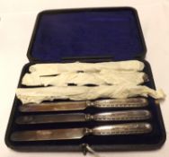 A cased set of six George V Steel Bladed Cake Knives with embossed Silver handles, Sheffield 1918