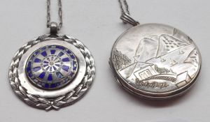 A hallmarked Silver Circular Locket, engraved with a lake and mountain scene, trace chain;