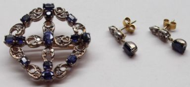 An unmarked precious metal Ring and Cross Design Brooch, set with Mid-Blue Sapphires and small