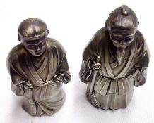 An interesting pair of Chinese white metal Models of Chinamen (hollow), with a burnished finish,