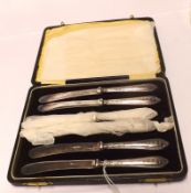 A cased set of six George V Plated Bladed Cake Knives with embossed Silver handles, Sheffield 1923