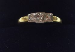 A hallmarked 18ct Gold Princess cut three Diamond Ring, line set, approximately .4ct total