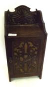 A 19th Century Oak Small Smoker’s Cabinet with fretwork carved back and similar panelled door