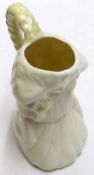 A 20th Century Belleek Jug, modelled as a kneeling girl with flowing golden hair, on a cream