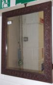 A rectangular Wall Mirror in a foliate carved Oak Frame, 17 ¾” wide