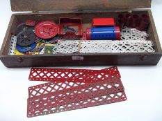 A quantity of miscellaneous Meccano parts and accessories, housed within oak case