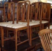 A set of six Edwardian Mahogany and line inlaid splat back Dining Chairs, with striped upholstered