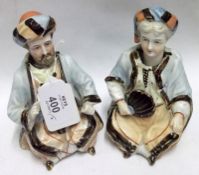 A pair of late 19th Century Bisque Nodding Head Figures, modelled as an Arabic couple, 5” high