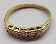 A hallmarked 18ct Gold five graduated small Diamond line set ring