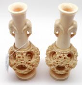 A pair of composition Spill Vases, the necks with moulded elephant mask handles above concentric