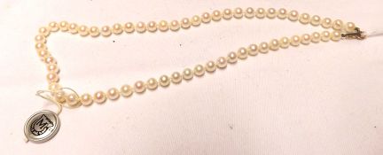 A cased set of ungraduated Mikimoto Cultured Pearls (Silver Seal), approximately 18cm long,