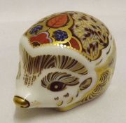 A Royal Crown Derby Paperweight, modelled as a hedgehog, decorated in red, blue and gold, fitted