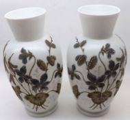 A pair of late 19th/early 20th Century French Opaque Glass Vases decorated with floral sprays on a