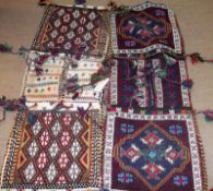 Two Turkish Saddlebag type Carpets, each decorated with geometric designs and having burgundy and