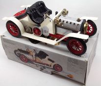 A Mamod Steam Roadster Open Touring Car in cream and red livery, housed within original box