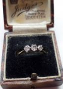 An unmarked yellow metal three small old cut Diamond Engagement Ring