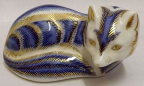 A Royal Crown Derby Paperweight, modelled as a recumbent fox, with blue striped finish, 4” long (