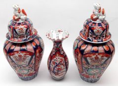 A pair of Japanese Imari Covered Baluster Vases, each decorated in the traditional manner in typical