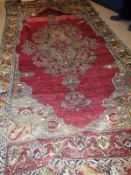A Turkish Mut Carpet with large central geometric lozenge and mainly mottled red and green/beige