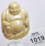 A small early 20th Century Carved Ivory Figure of a Buddha holding a beaded garland, 2”, (minor