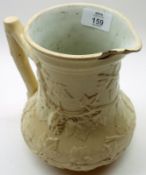 A 19th Century Jug embossed with grape vine design on a cream background (chip to lip), 7” high
