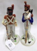 A pair of 20th Century Continental Figures of Soldiers, decorated in colours on round plinth
