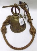 A 20th Century Wall Mounted Brass Bell, decorated with mythological figures, fitted with a rope pull
