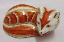 A Royal Crown Derby Paperweight, modelled as a recumbent fox, with red and gold striped finish, 4”