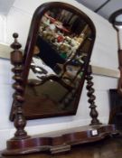 A Victorian Mahogany Swing Mirror, with arched mirror back raised on twisted columns terminating