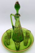 A Decorative early 20th Century Green Glass Liquor Set, comprises a Decanter gilded with scrolls and
